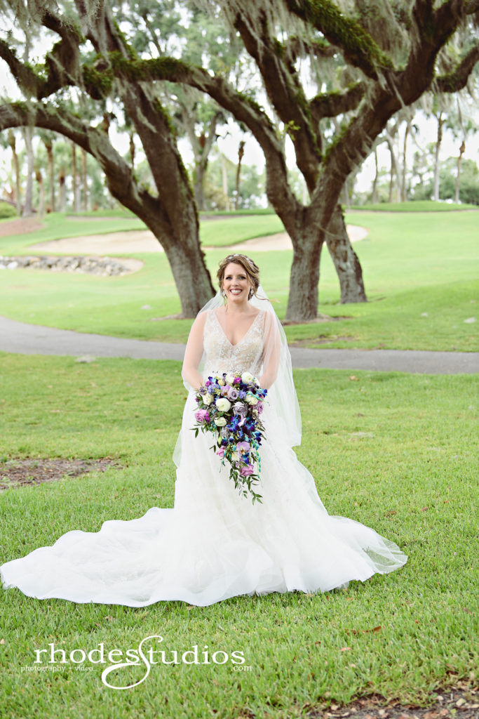 Beautiful bride holding a blue and purple cascading bouquet at Mission Inn