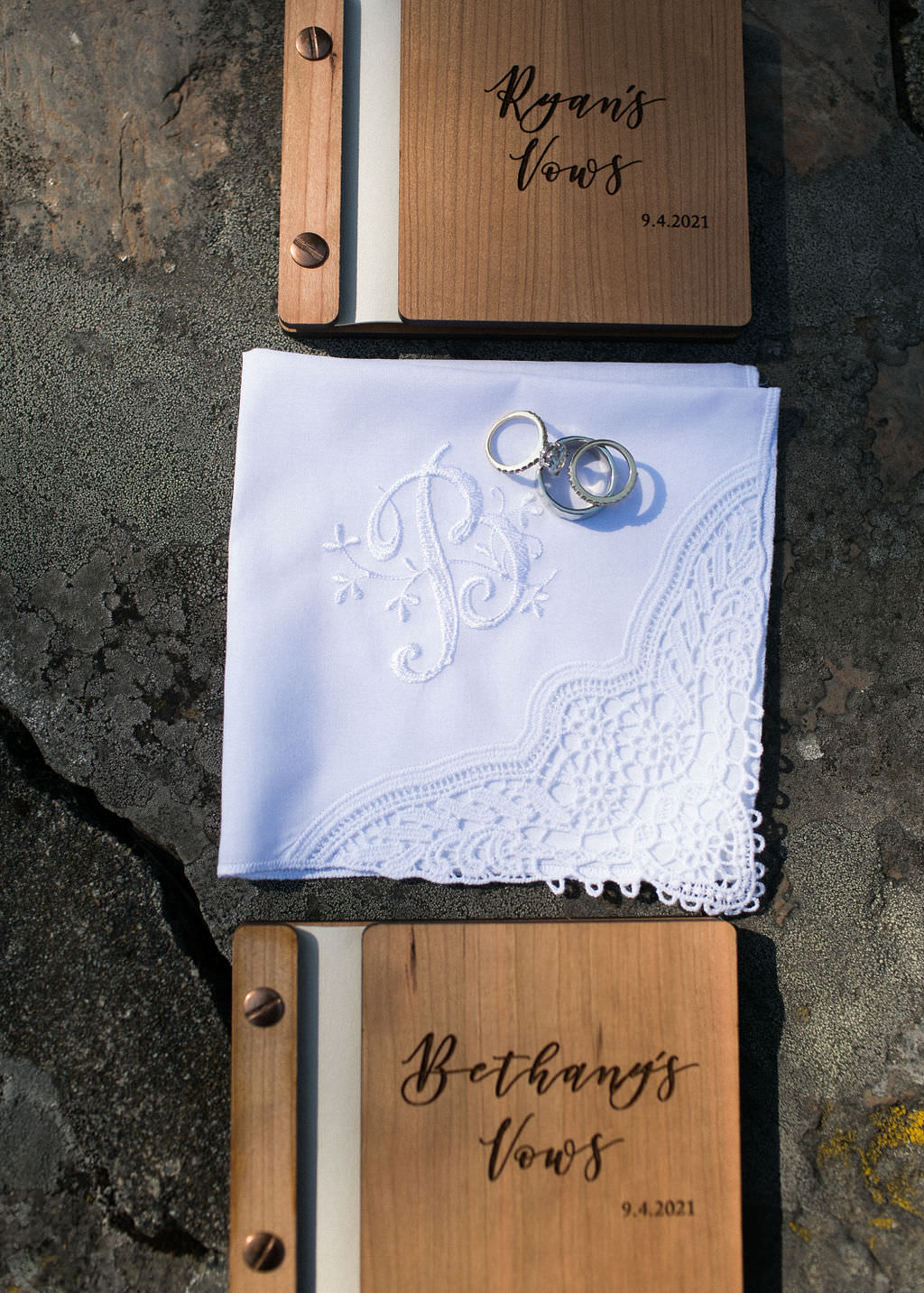 Bride and groom's wooden vow books, handkerchiefs and wedding rings
