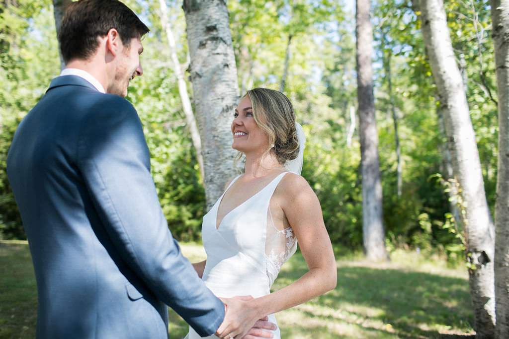 Bride and groom smiling at each other at a Montana wedding venue