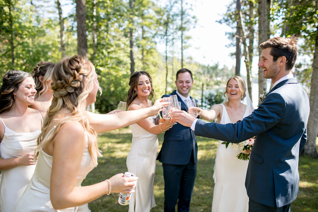 Bride and groom toasting with wedding party at Six Mile Estate, a Montana wedding venue