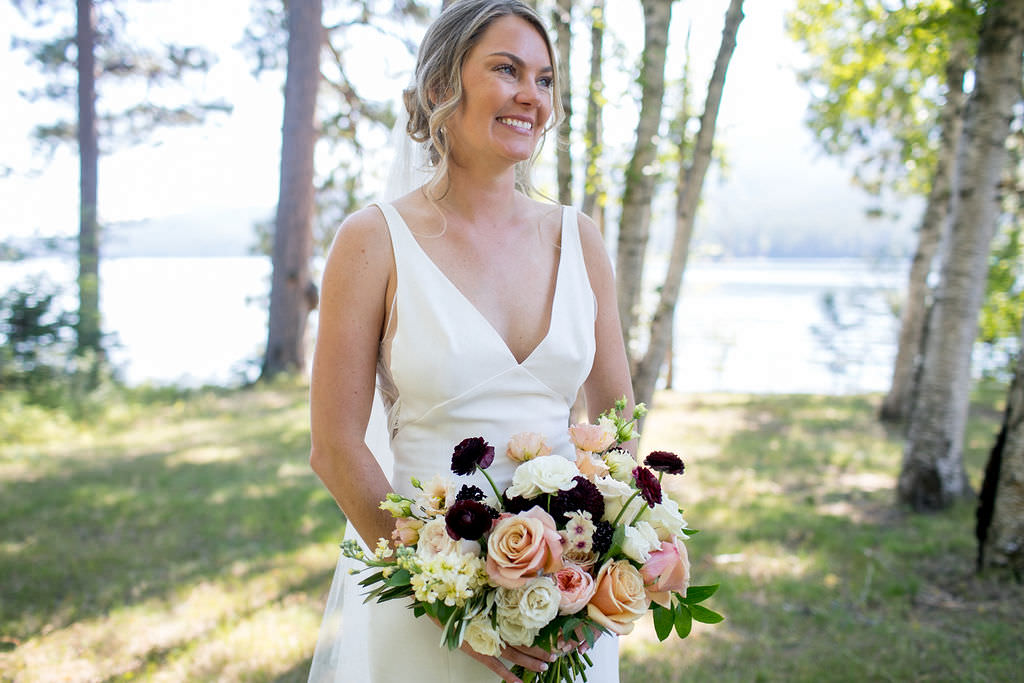Bride smiling with bouquet
