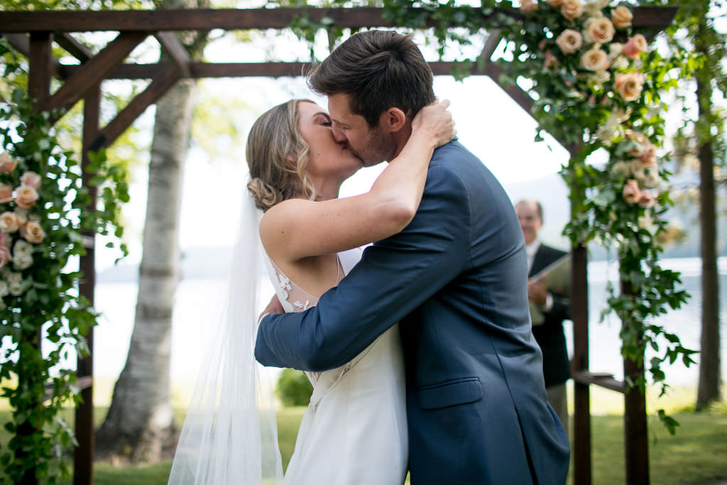 Bride and groom's first kiss at Six Mile Estate, a Montana wedding venue