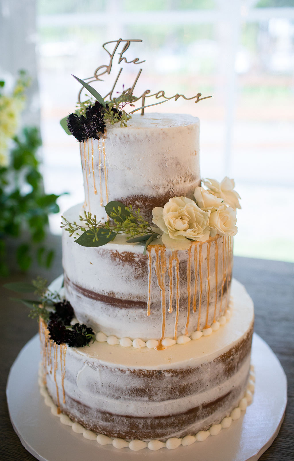 Naked wedding cake with flowers at at Six Mile Estate, a Montana wedding venue