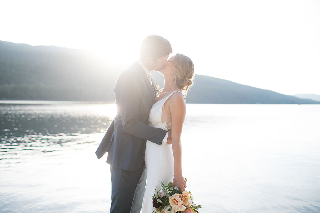 Bride and groom kissing at Six Mile Estate, a Montana wedding venue