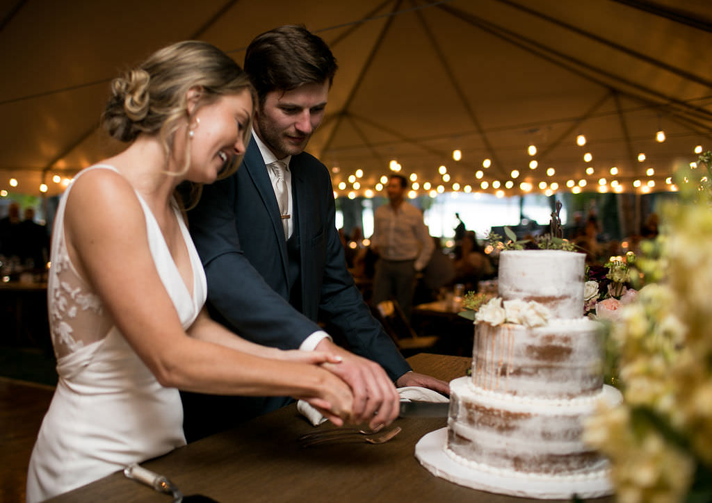Bride and groom cutting the cake at Six Mile Estate, a Montana wedding venue