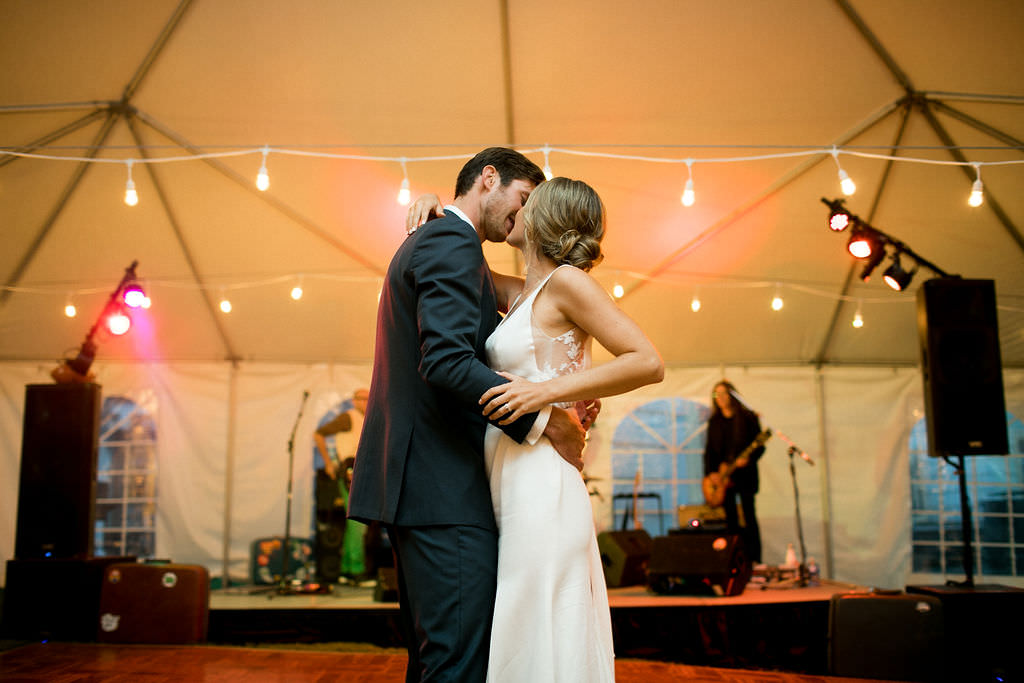 Bride and groom kissing on dance floor at at Six Mile Estate, a Montana wedding venue