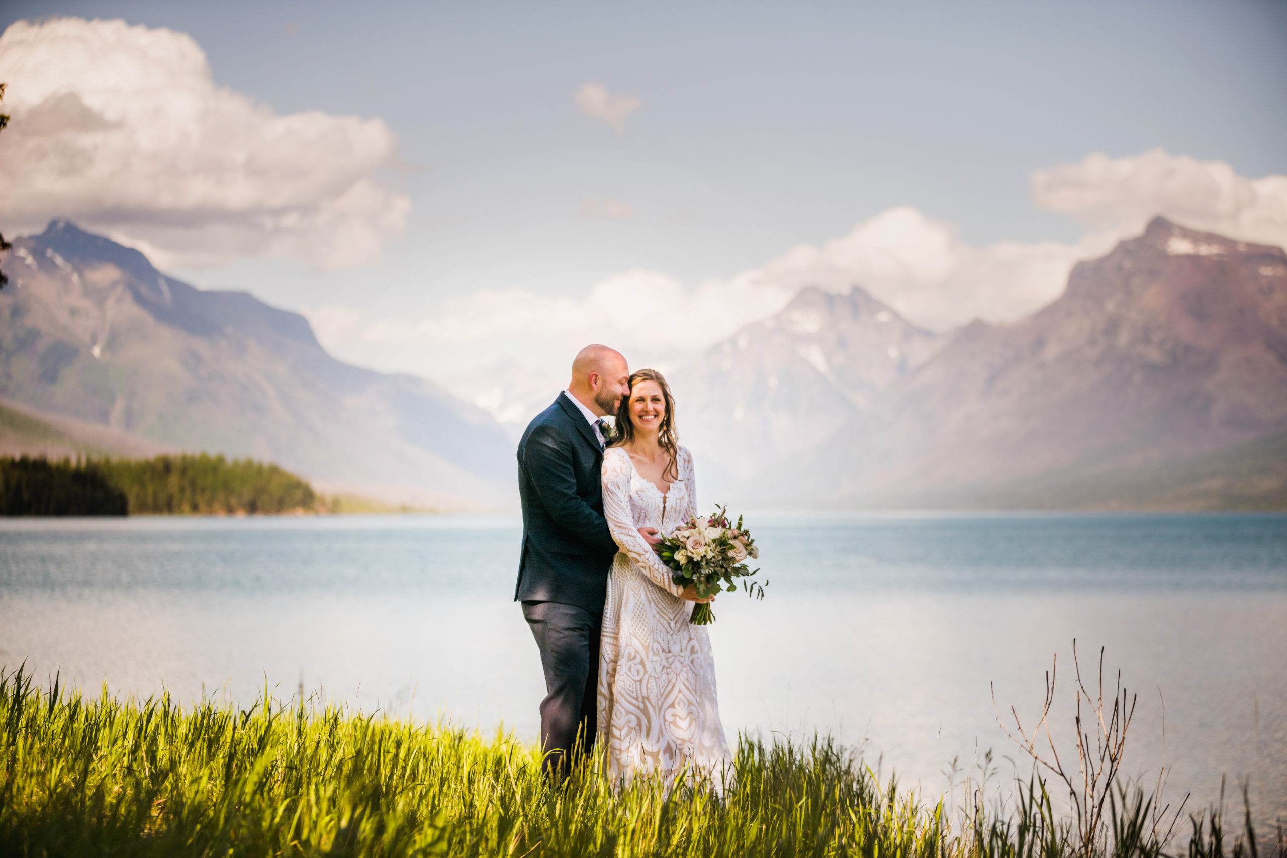 Bride and groom smiling at Glacier National Park at their wedding in the mountains