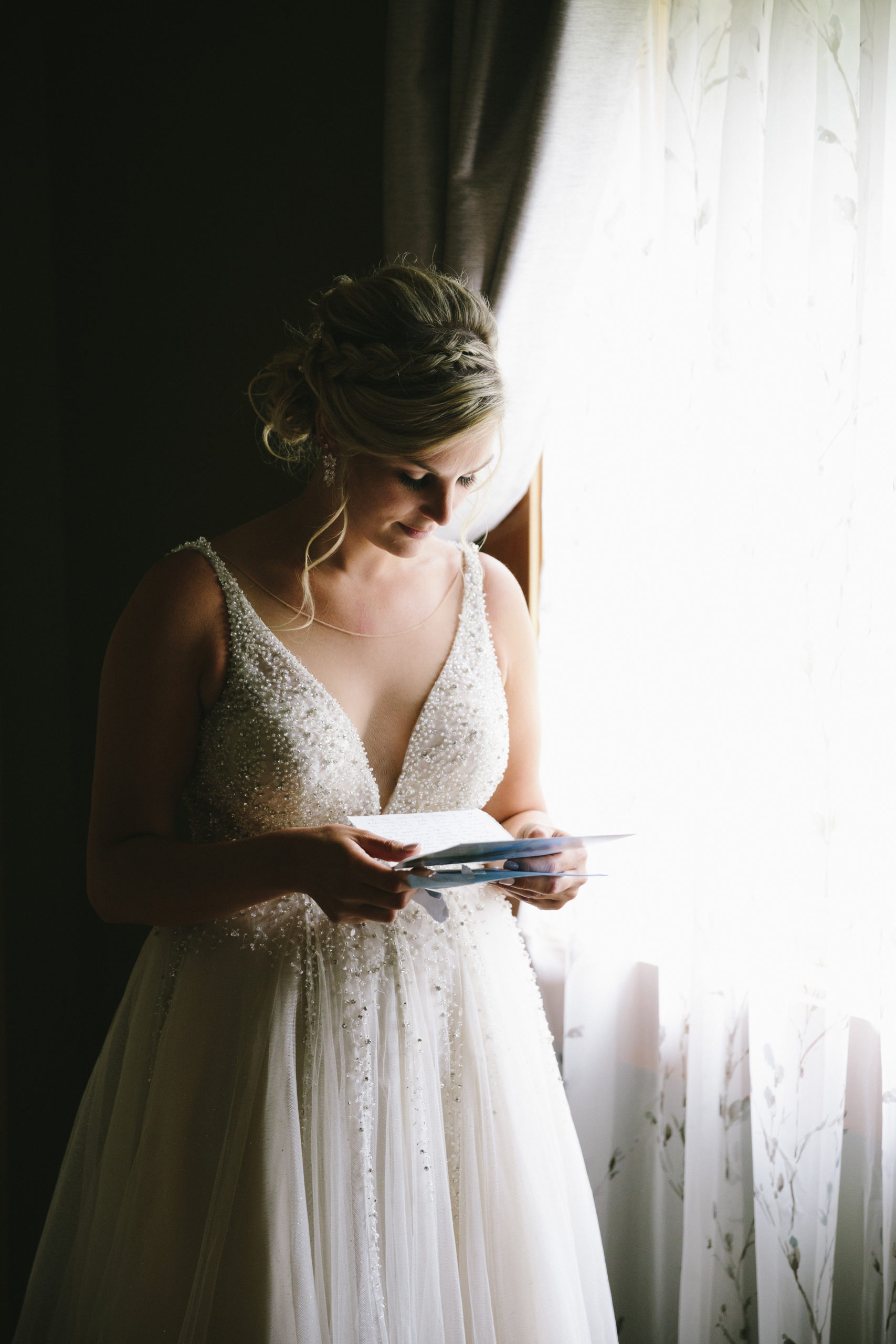 Bride reading letter from groom at their ranch wedding