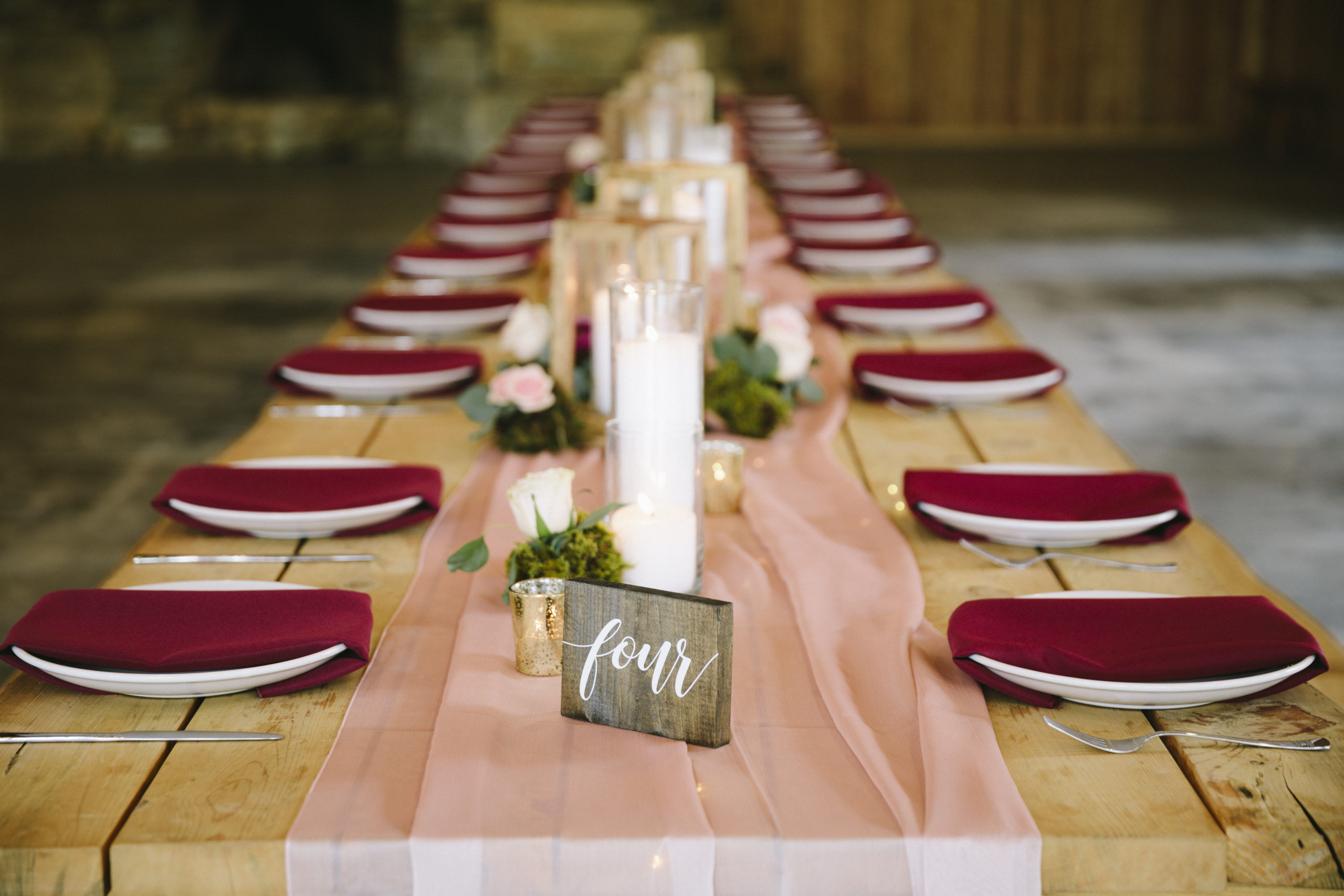 Rust and raspberry tablescape at a ranch wedding reception
