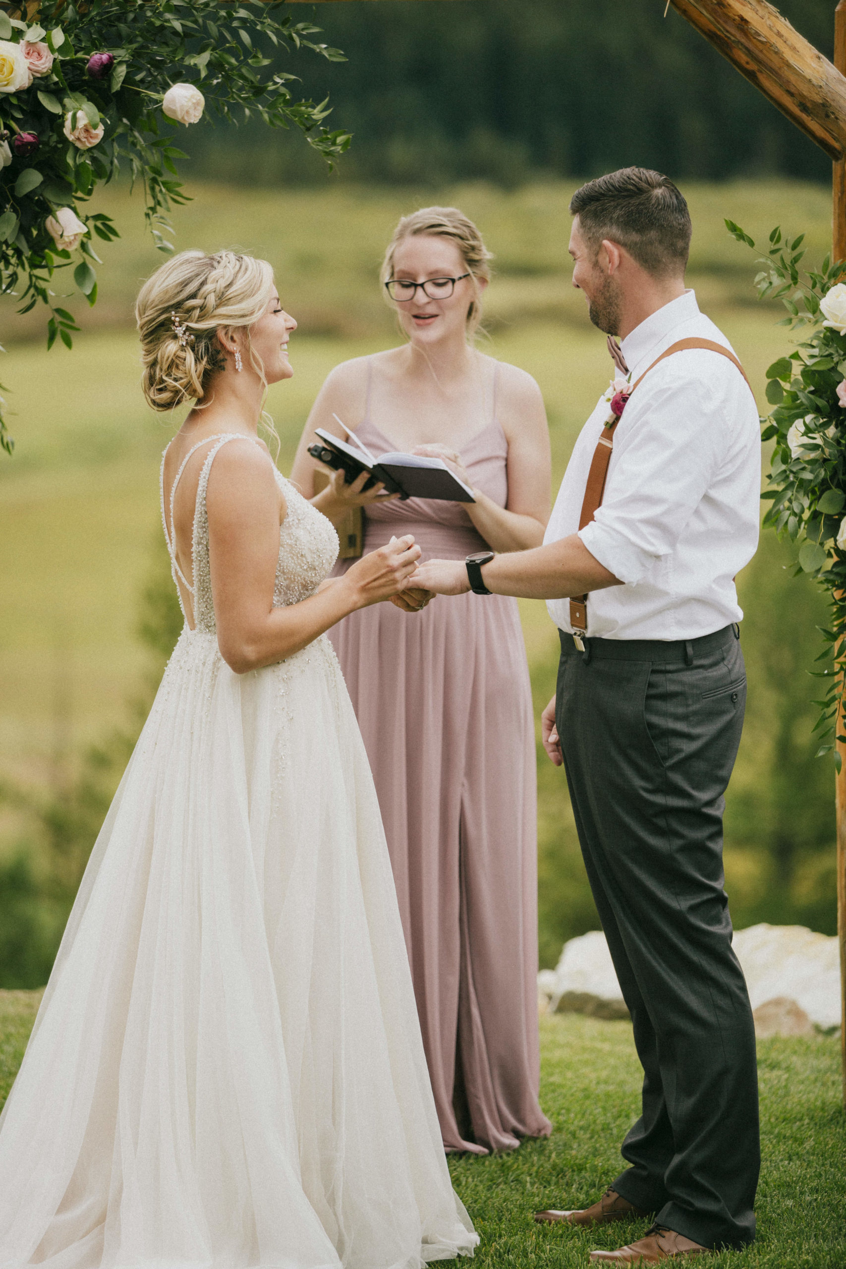 Bride, groom, and officiant at ranch wedding ceremony
