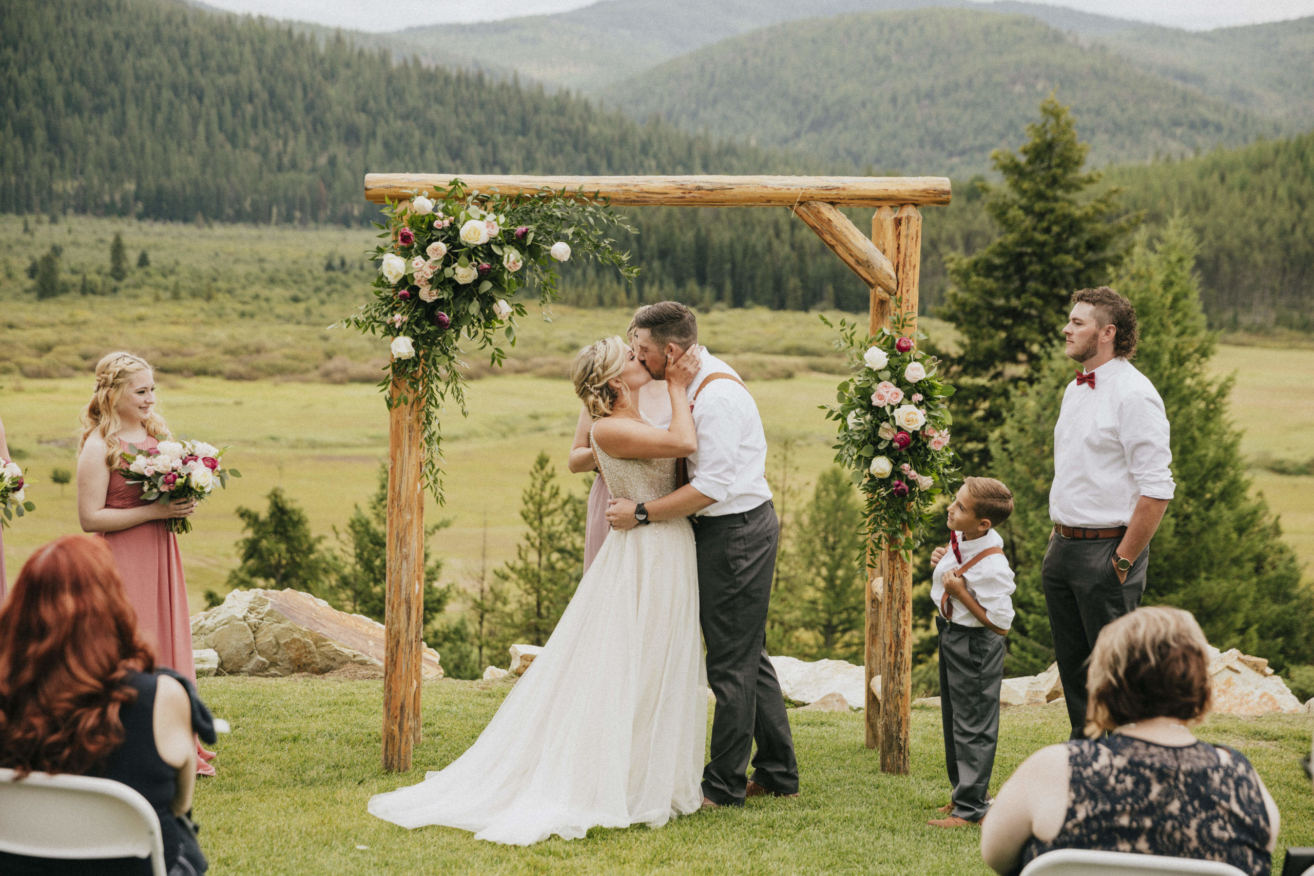 Bride and groom's first kiss at their ranch wedding